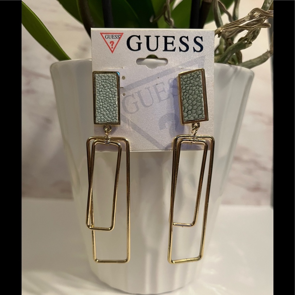 Woman’s earrings bundle of two Guess and unbranded gold and silver earrings.